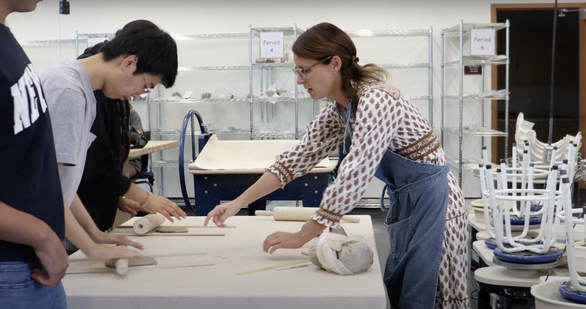 Art teacher, Kelly Casassa helps students on a ceramic's project. Casassa received her doctorate in art. Photo courtesy of Coral Diaz. 